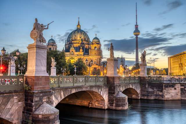 A view of a Cathedral, the TV Tower and the Schlossbruecke at night in Berlin, Germany