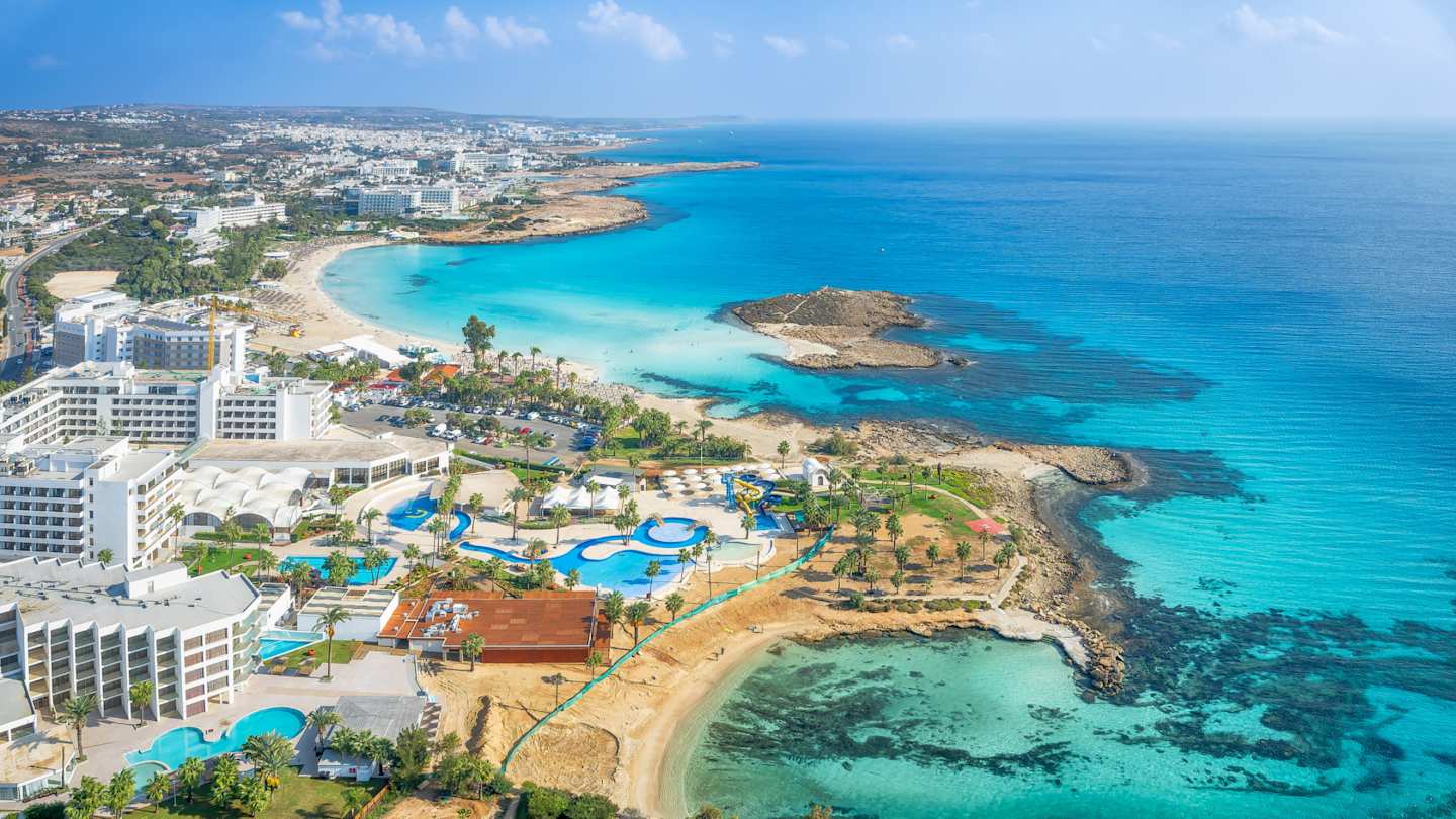 Landscape of sea, shore, and buildings surrounding Nissi Beach, Ayia Napa, Cyprus