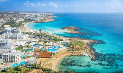 Landscape of sea, shore, and buildings surrounding Nissi Beach, Ayia Napa, Cyprus