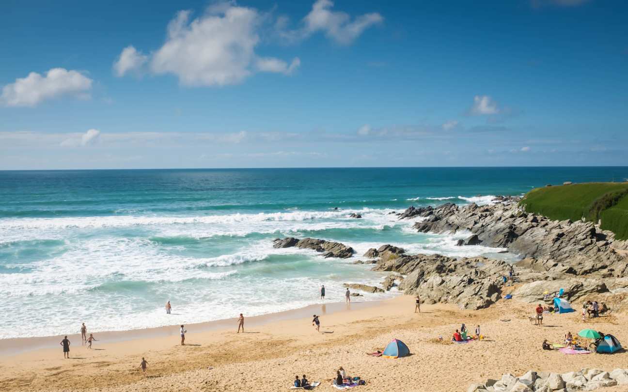 Families relaxing and playing on Fistral Beach near Newquay, Cornwall