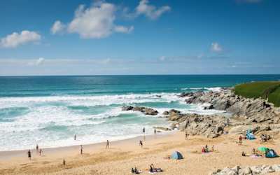 Families relaxing and playing on Fistral Beach near Newquay, Cornwall