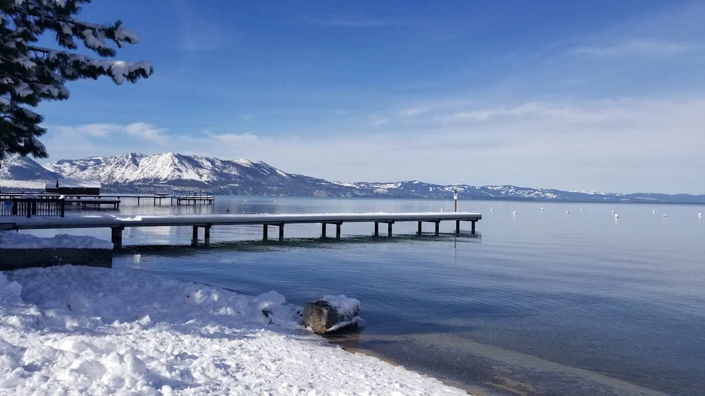 A pier and mountains in South Lake Tahoe in Winter