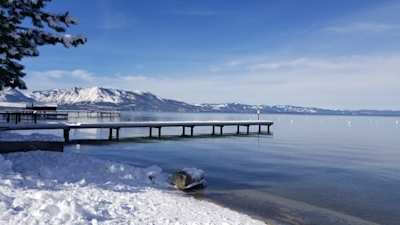 A pier and mountains in South Lake Tahoe in Winter