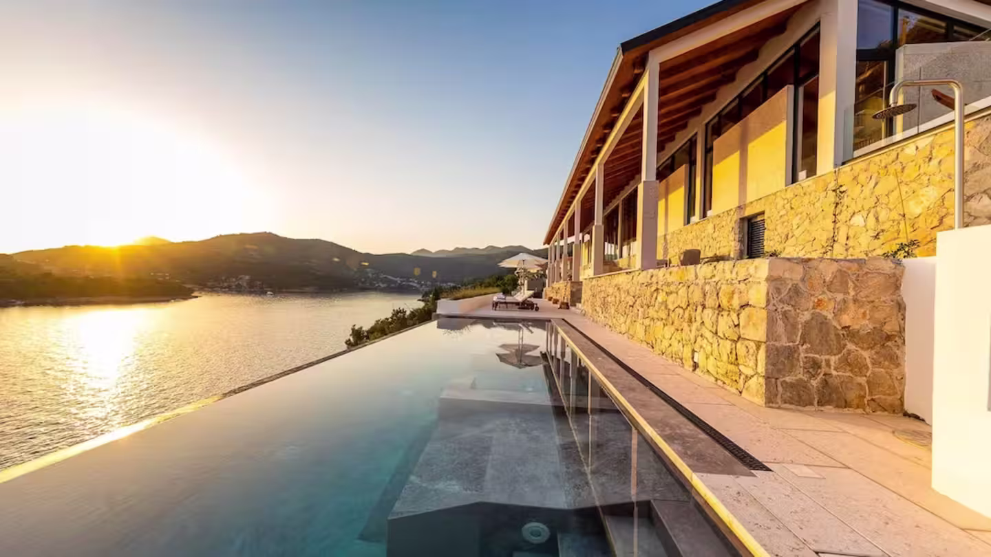 Stone villa with an infinity pool and sea views captured at sunset, Infinite Beauty, Plum Guide in Dubrovnik