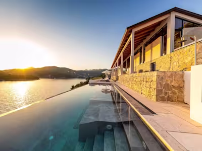 Stone villa with an infinity pool and sea views captured at sunset, Infinite Beauty, Plum Guide in Dubrovnik