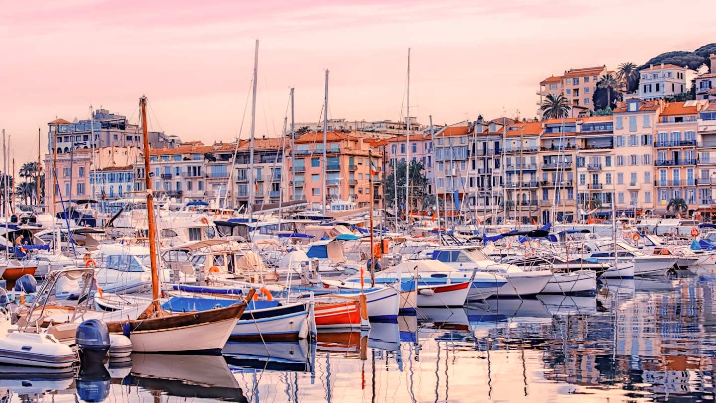 Fishing boats and yachts in Old Harbour at sunset, Cannes