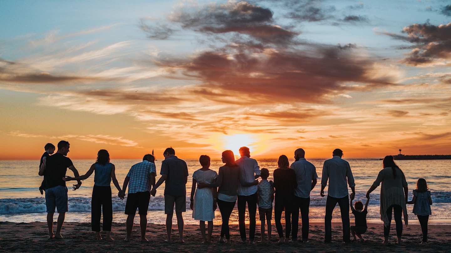 Family together on a beach at sunset