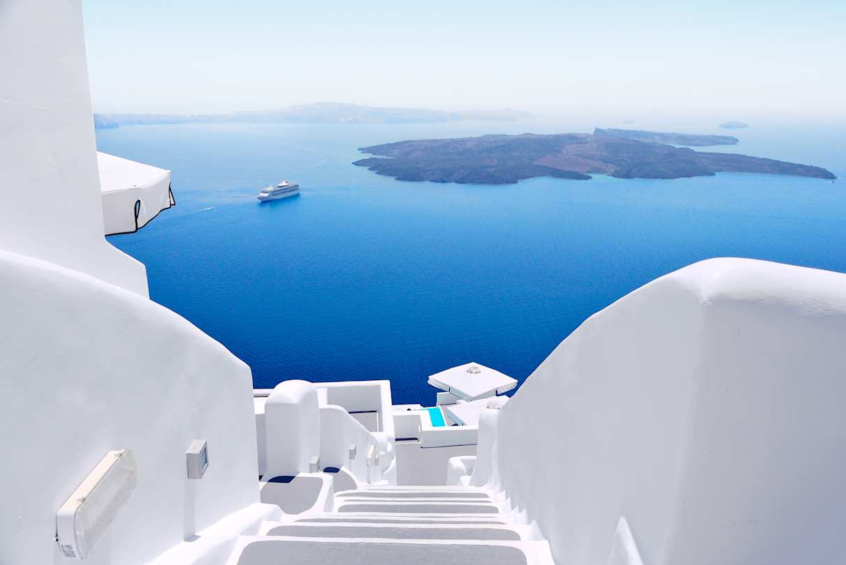 A view of white walls and steps overlooking the sea from high up, Santorini, Greece