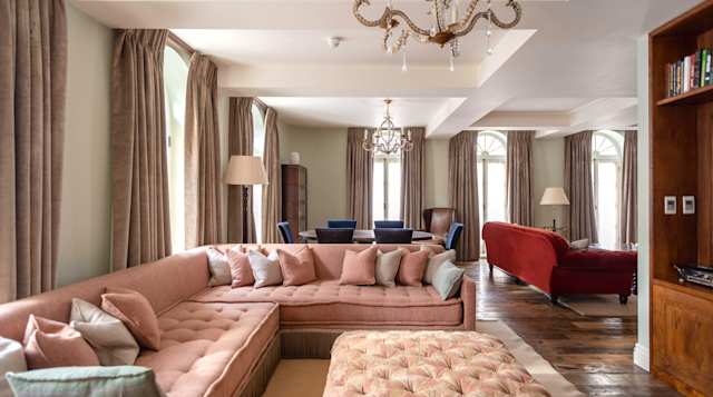 Pink sofa in living room of home in Mayfair