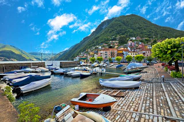 Boats docked in the colourful village of Argegno, Lake Como