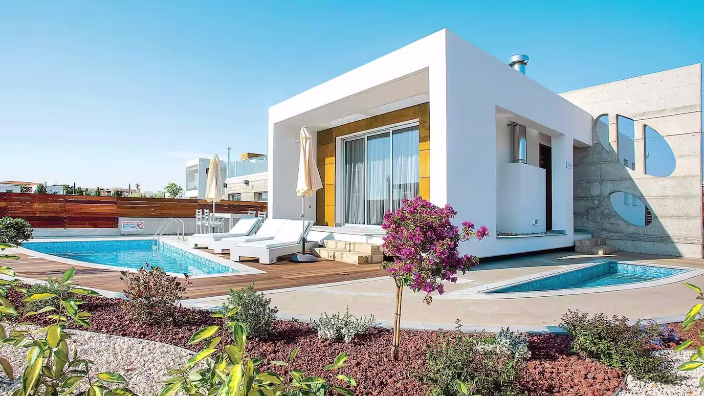 Sugar Cube, a white-washed home with Mediterranean shrubs and a private swimming pool in Paphos, Cyprus