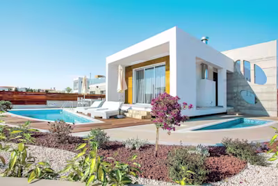 Sugar Cube, a white-washed home with Mediterranean shrubs and a private swimming pool in Paphos, Cyprus