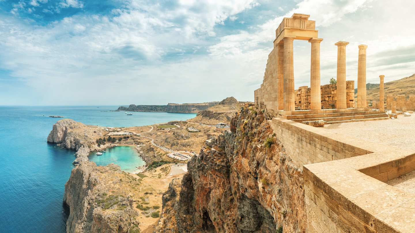 A view of the Acropolis of Lindos on a cliff above the blue sea, Rhodes, Greece