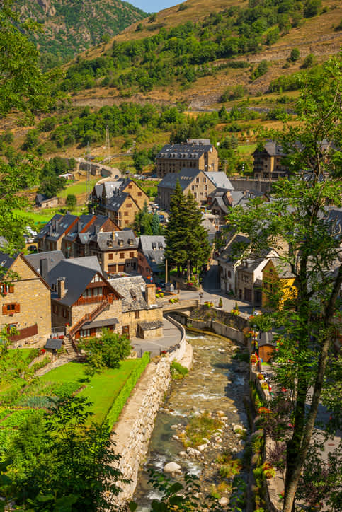 Stone houses and a small river on a summer day, village of Tredos, near Baqueira-Beret