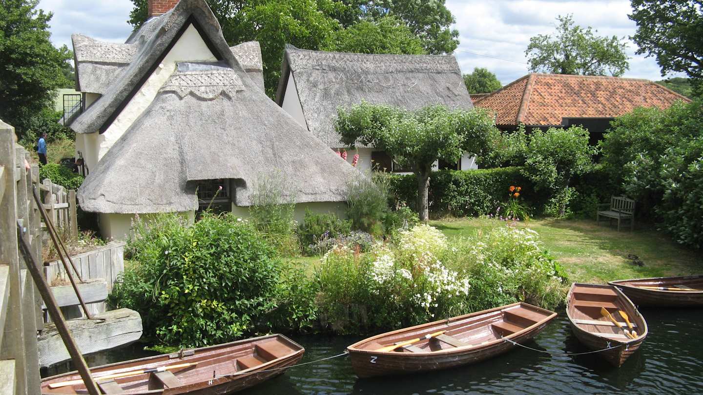 Cottages and boats at the National Trust Centre, Flatford, Dedham Vale, Suffolk