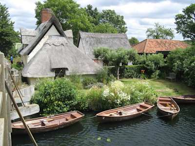 Cottages and boats at the National Trust Centre, Flatford, Dedham Vale, Suffolk