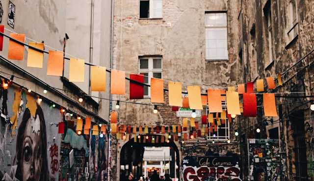 photo of buntings hanged near graffiti artworks in Berlin