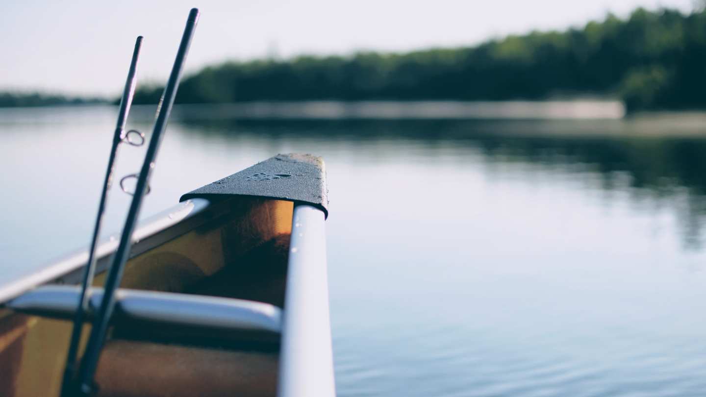 Boat on water with fishing rods