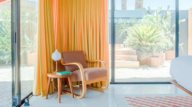 Alvar Aalto chair in the bedroom at Desert Wave, Plum Guide home in Palm Desert