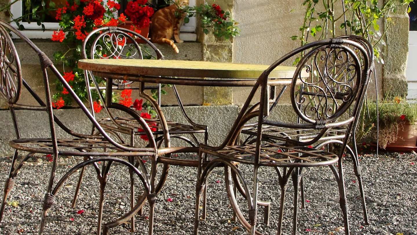 Table and chairs outside a house in Paris in March