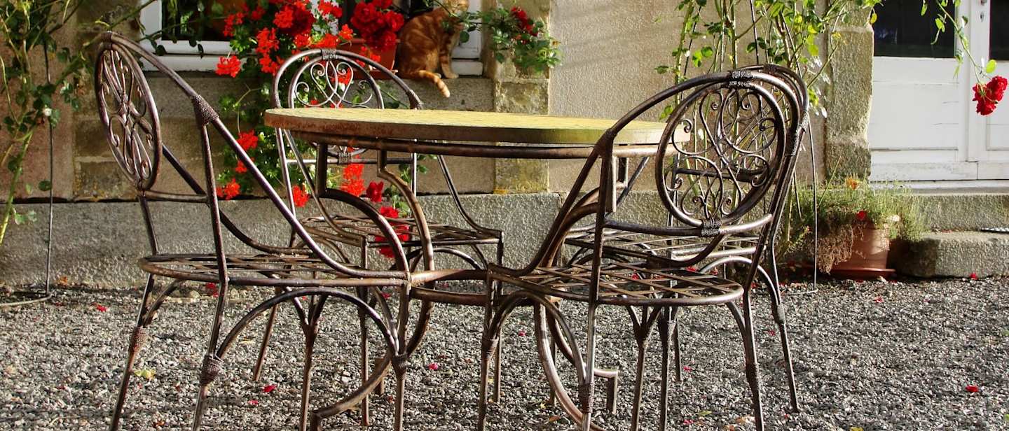 Table and chairs outside a house in Paris in March