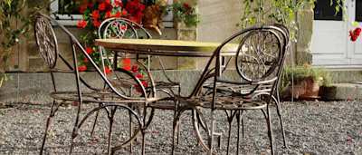 Table and chairs outside a house in Paris in March