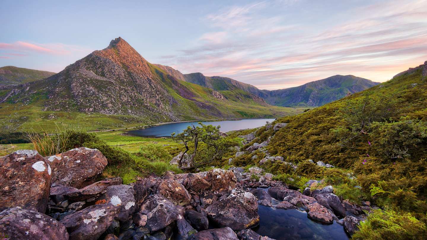 Snowdonia National Park in Northern Wales, with small lake and craggy mountains, Wales