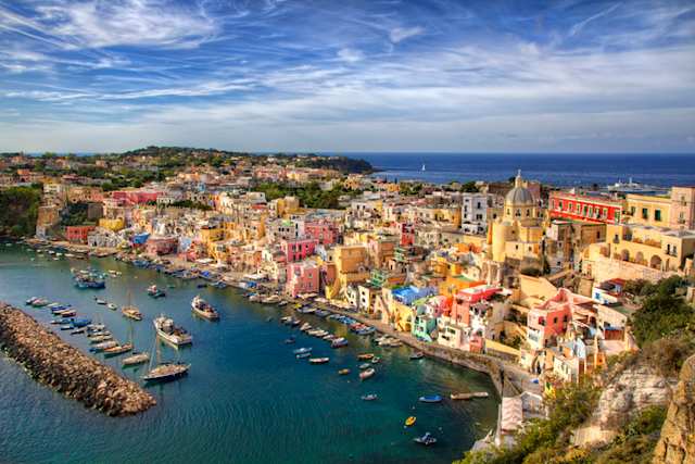 An aerial view of the harbour and colourful buildings in the city of Corricella, Island of Procida, Bay of Naples, Italy