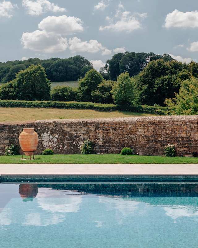 Pool overlooking fields of The Bronze Knight, Plum Guide home in Cotswolds