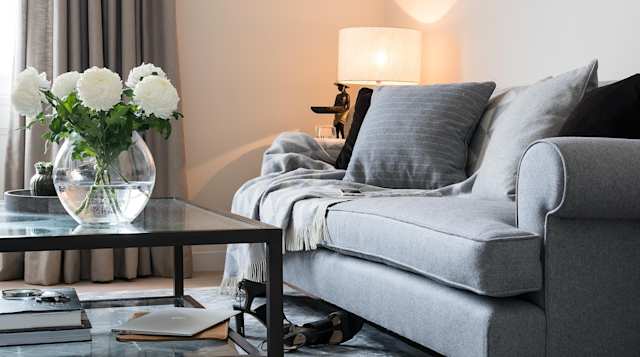 Sofa, cashmere throws and plant vase in The Earl's Boutique, Plum Guide home