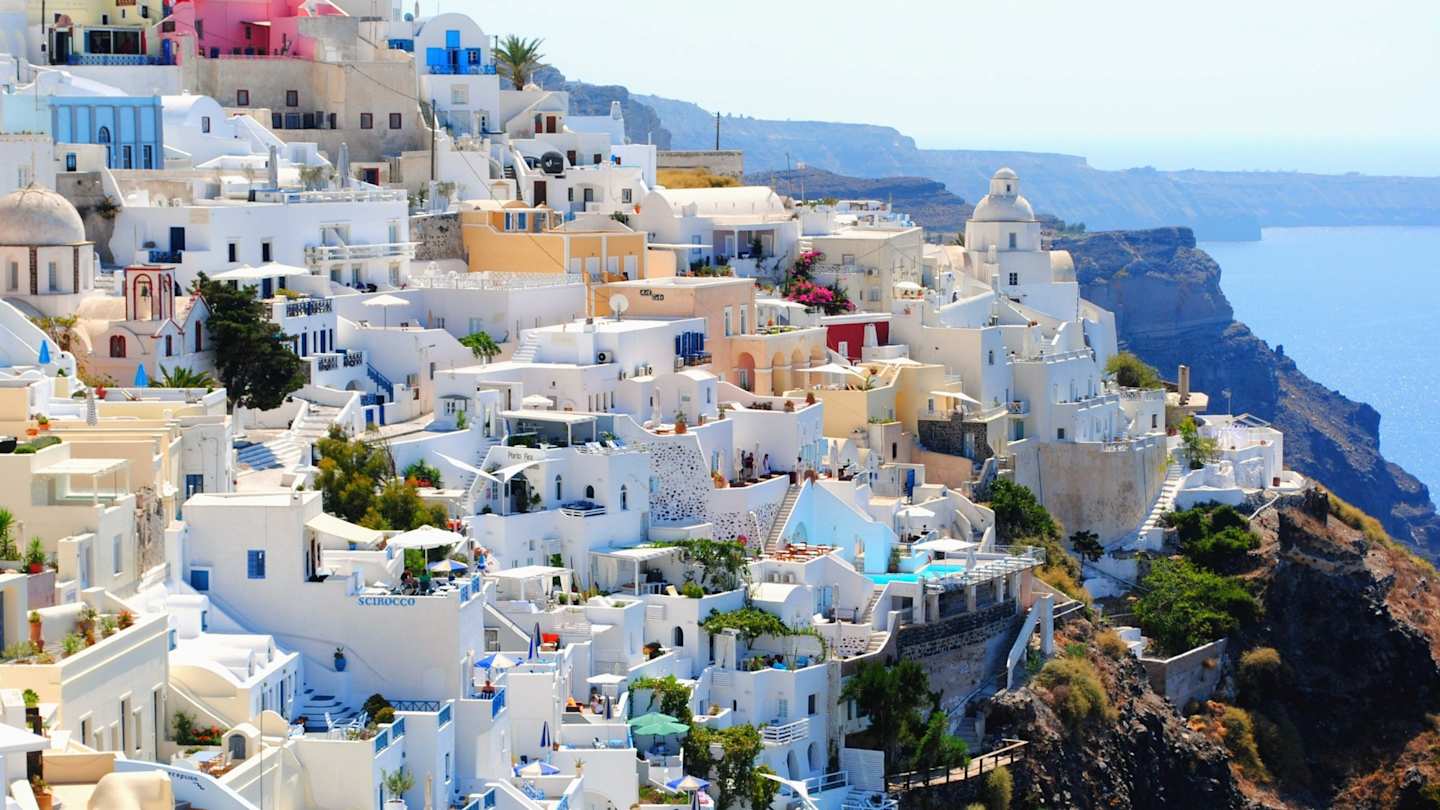 A shot of clustered white buildings in Santorini, Greece