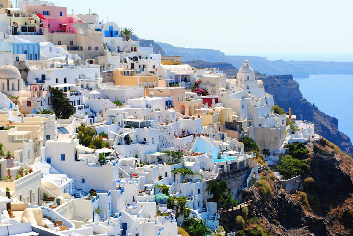 A shot of clustered white buildings in Santorini, Greece
