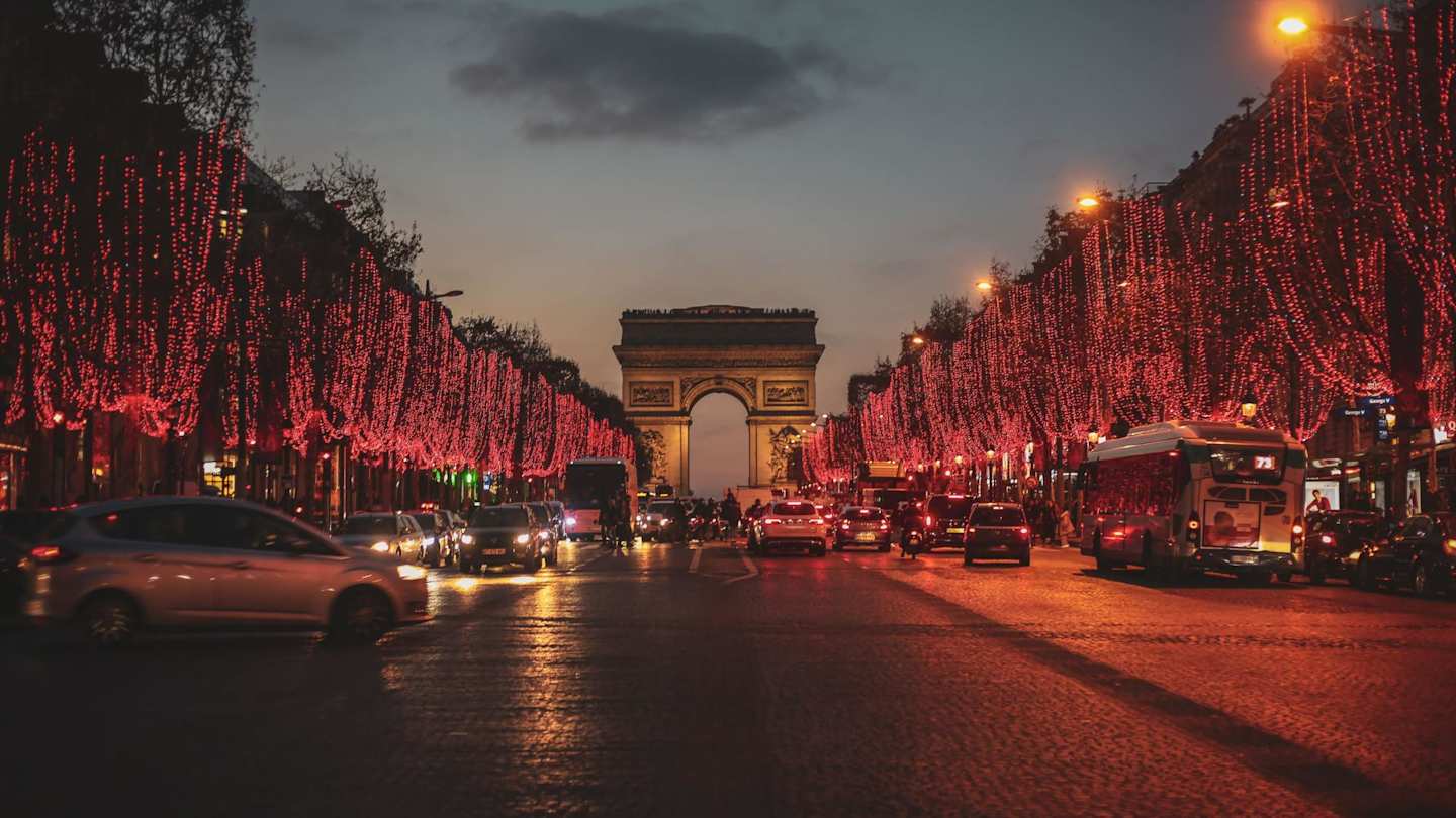 Arc de Triomphe and trees covered in Christmas lights at night, Paris, France