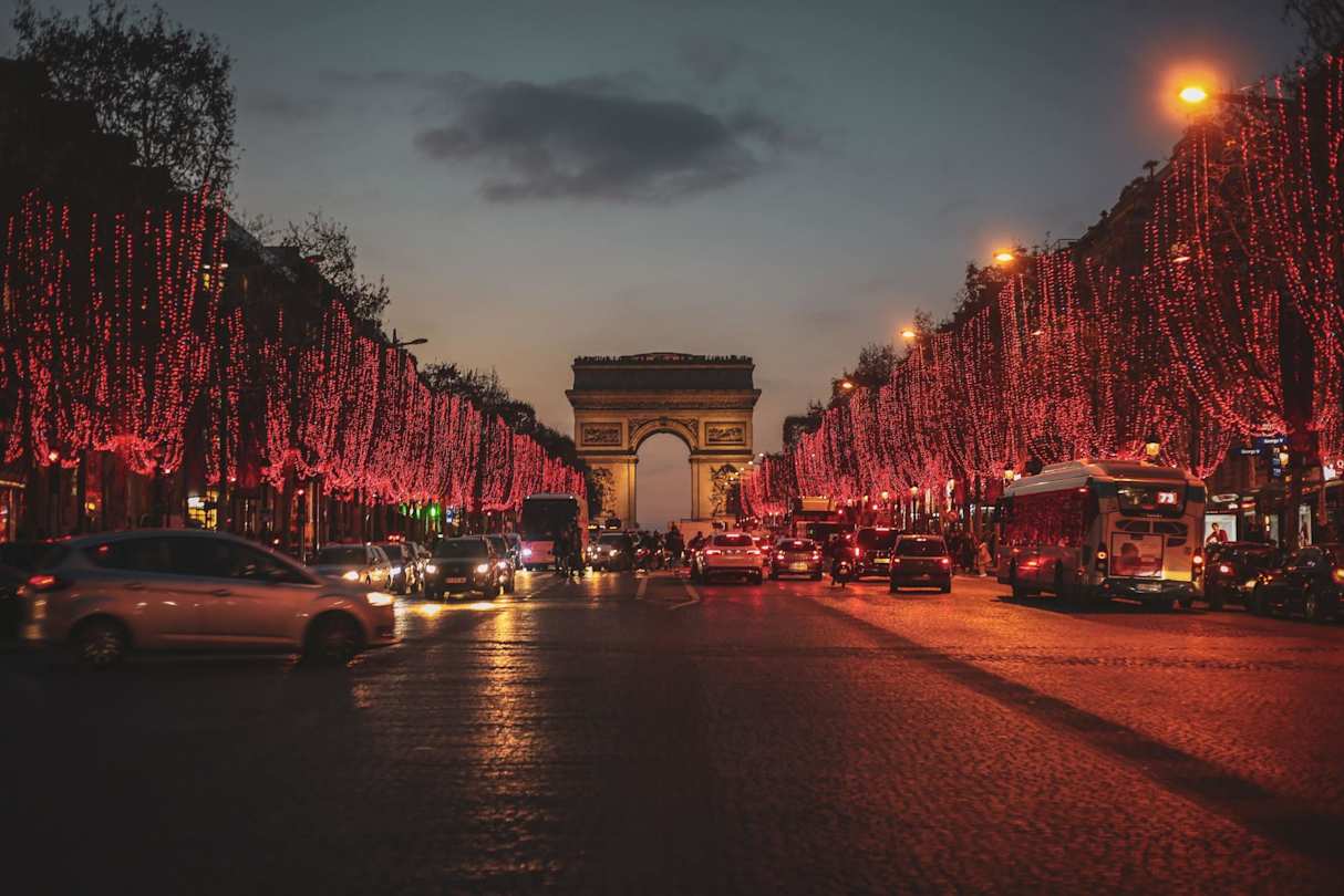 Arc de Triomphe and trees covered in Christmas lights at night, Paris, France