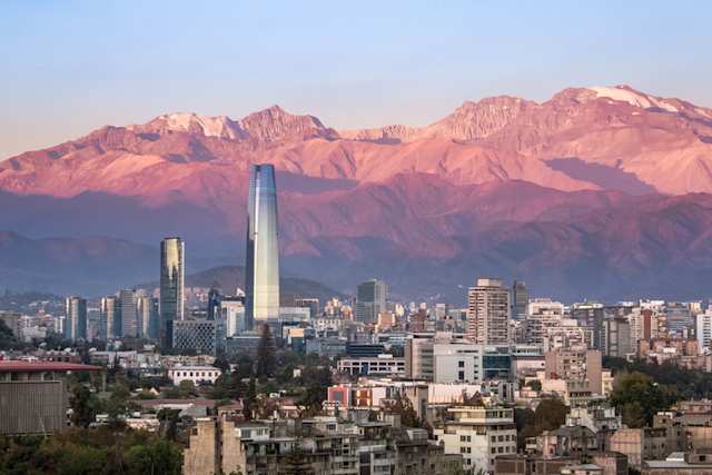 Santiago skyline at sunset with Costanera skyscraper and Andes Mountains, Santiago, Chile