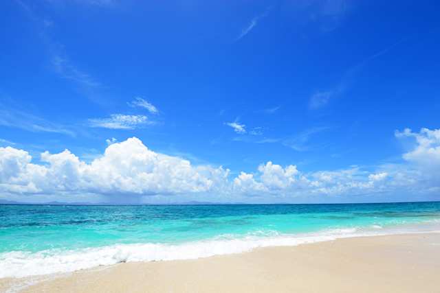A pristine sandy beach with a blue sky in summer in Okinawa, Japan