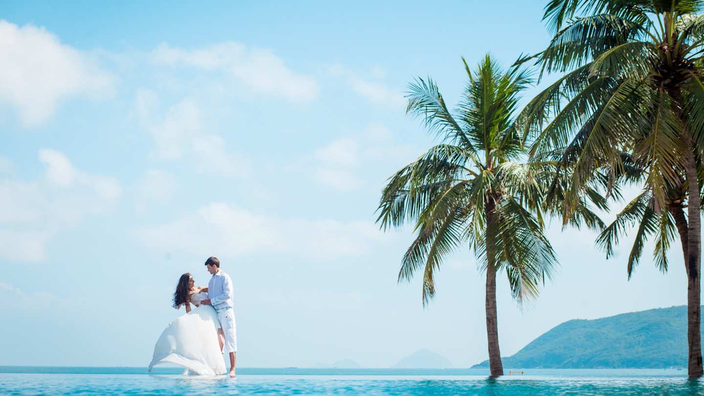 A newly-wed couple celebrating their wedding in an exotic destination