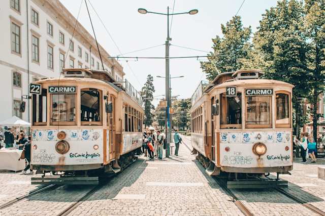 Two beige trams on a sunny day in the city centre, Porto, Portugal