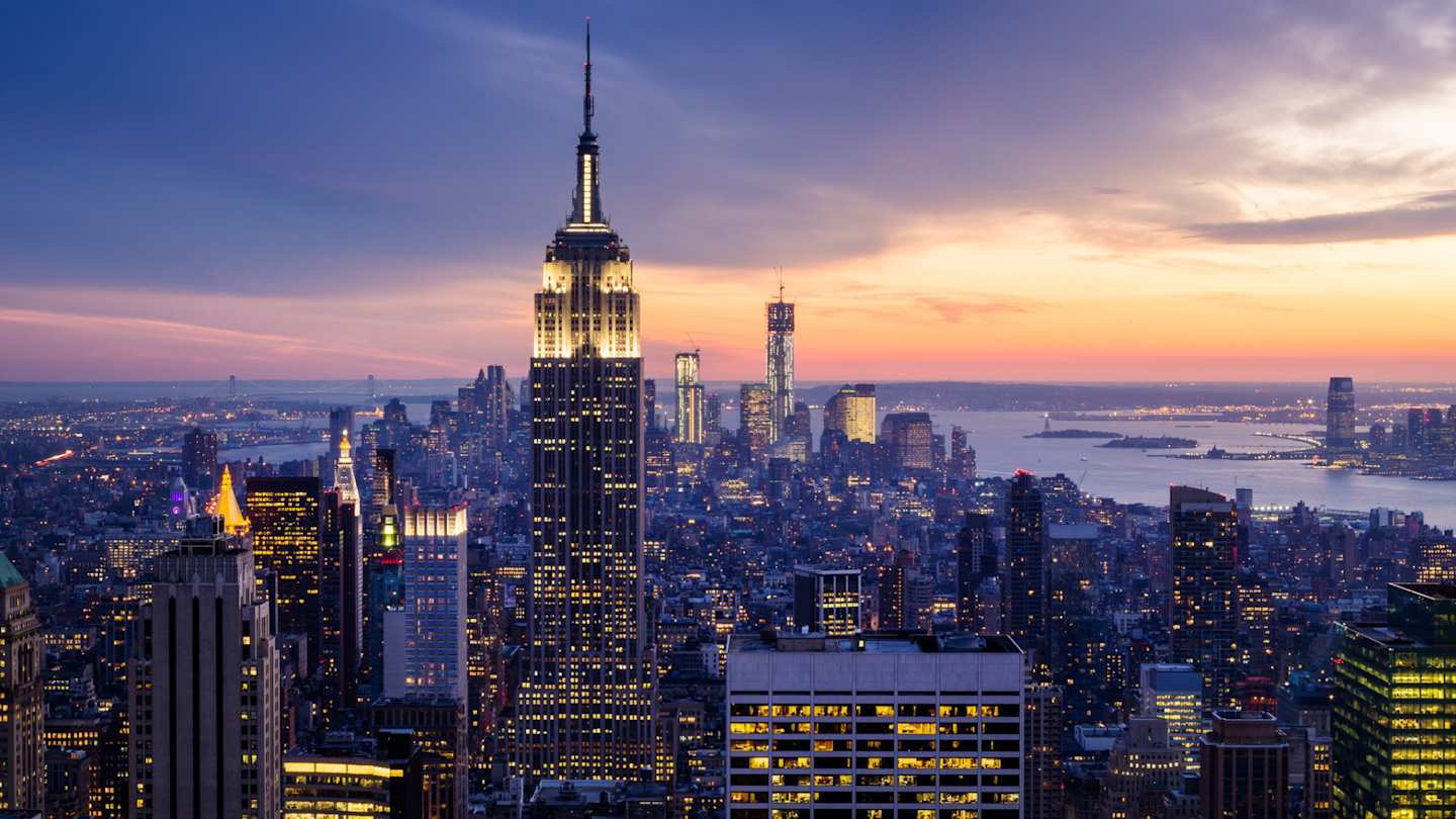 A view of the skyline with skyscrapers and the River Hudson at night, New York City, USA