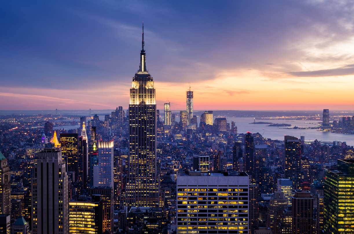 A view of the skyline with skyscrapers and the River Hudson at night, New York City, USA