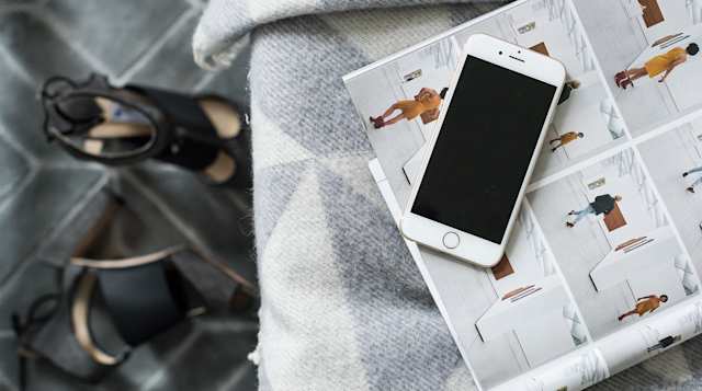 Magazines and mobile phone on sofa inside the Earl's Boutique, Plum Guide home