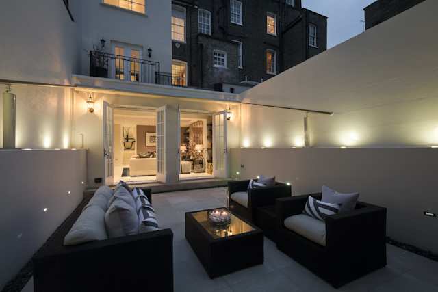 Outdoor terrace area at night time in Belgravia home