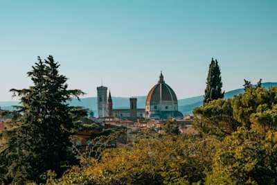 View of the Duomo from high up behind some trees, Florence, Italy
