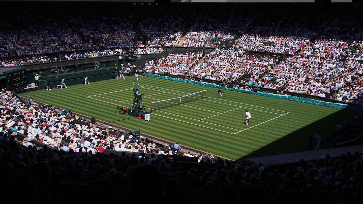 Roger Federer and Dusan Lajovic playing tennis at Wimbledon Championships, London