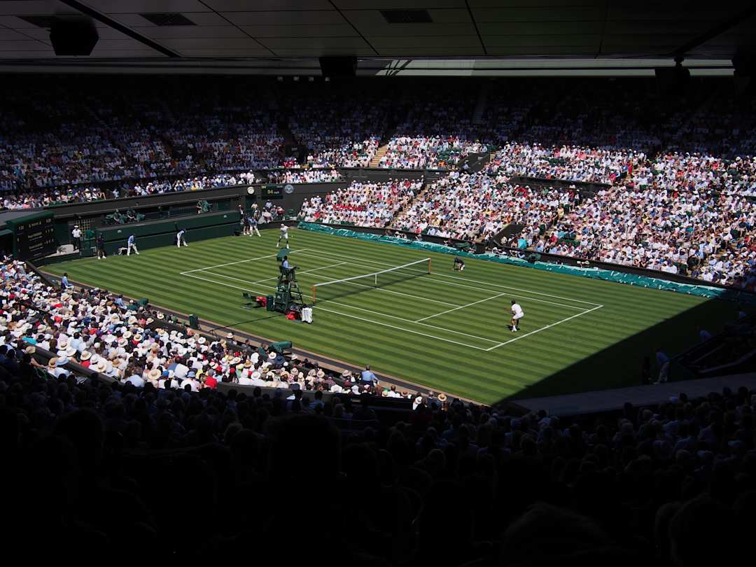 Roger Federer and Dusan Lajovic playing tennis at Wimbledon Championships, London