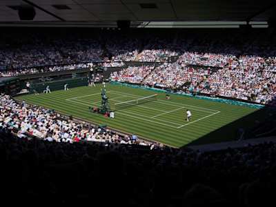 Roger Federer and Dusan Lajovic playing tennis at Wimbledon Championships, London