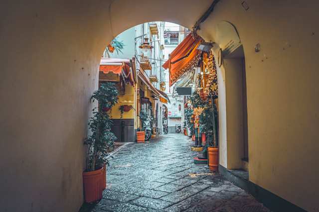 Picturesque street with archway and stores in Sorrento, Italy