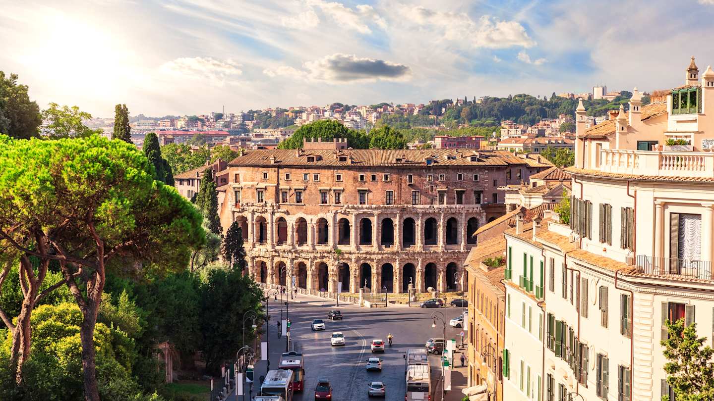 A tree-lined street leading to the Teatro di Marcello in Rome, Italy