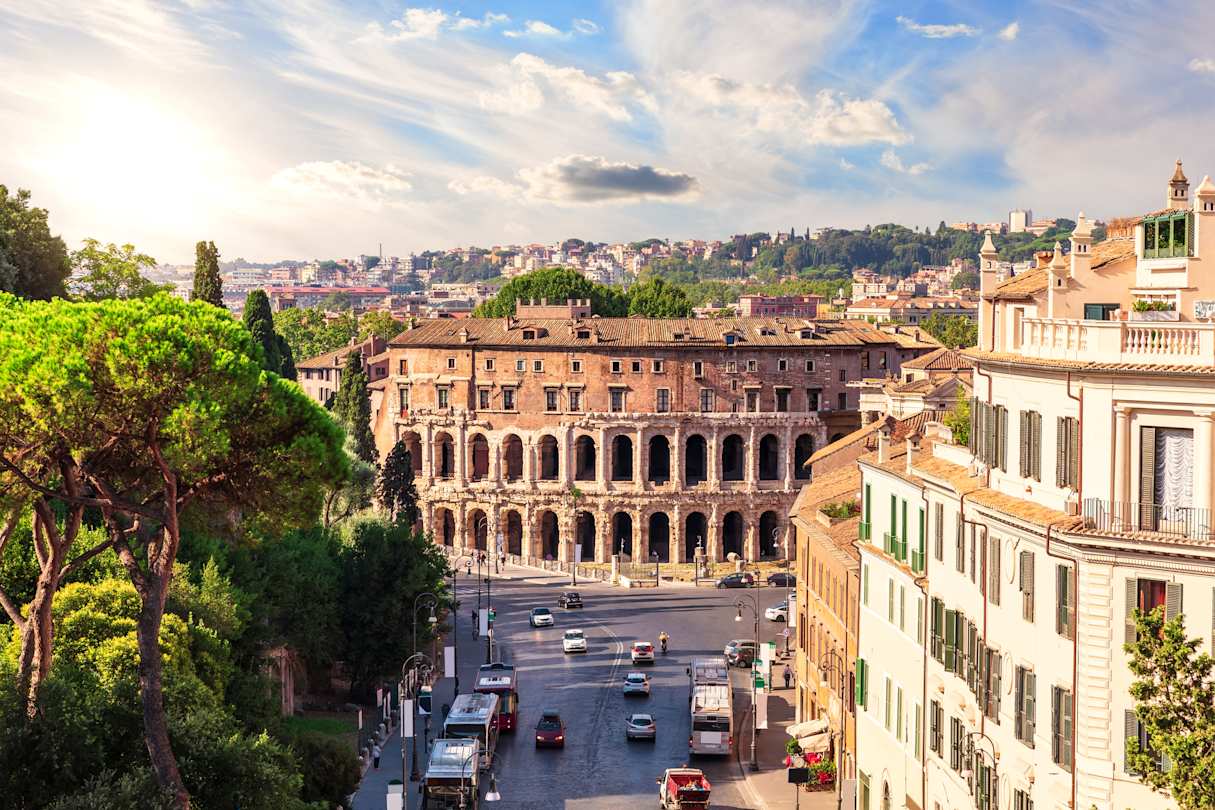 A tree-lined street leading to the Teatro di Marcello in Rome, Italy