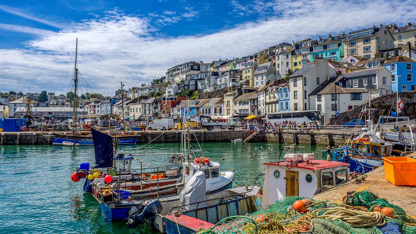 Colourful houses and fishing boats in the harbour in Brixham, Devon
